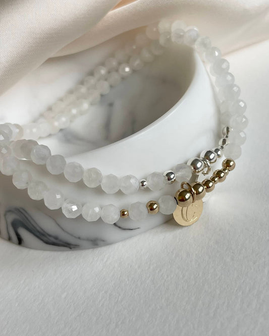 Moonstone June birthstone bracelet: Close-up of a stretch bracelet with natural Moonstone gems, reflecting light. Elegant design, strong stretch cord, and an exclusive Moon & Star charm. Perfect for June birthdays, symbolizing intuition and new beginnings.