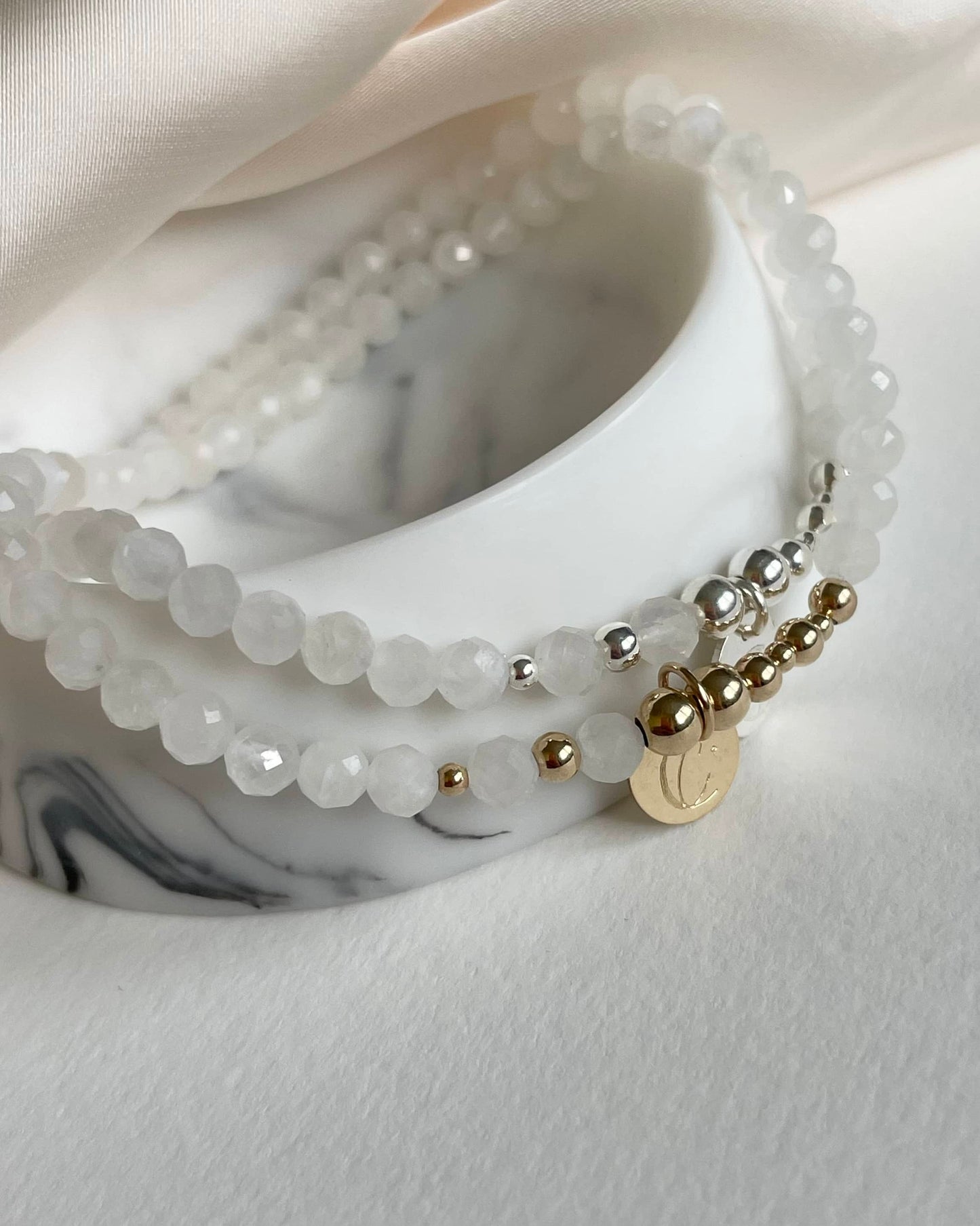 Moonstone June birthstone bracelet: Close-up of a stretch bracelet with natural Moonstone gems, reflecting light. Elegant design, strong stretch cord, and an exclusive Moon & Star charm. Perfect for June birthdays, symbolizing intuition and new beginnings.