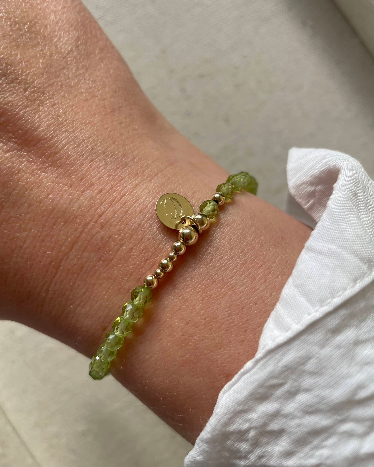 Peridot Bracelet with Gold Filled beads and celestial Star and Moon charm. Made by Clarity and Calm in UK, Northamptonshire.